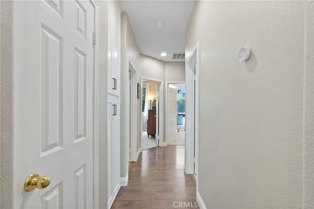 a view of hallway with closet and mirror