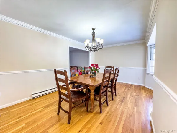 a dining room with furniture and wooden floor