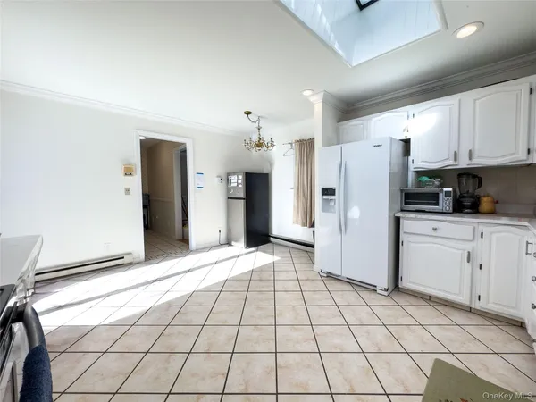 a view of a kitchen with electric appliances