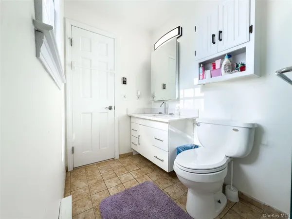 a bedroom with furniture and a flat screen tv