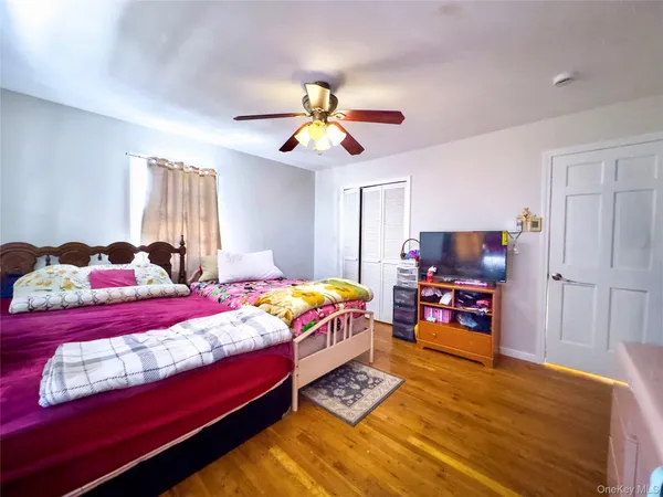 a bedroom with two beds and a tv