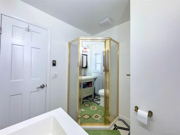 a living room with a bed furniture and a flat screen tv