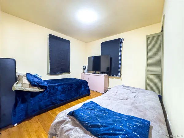 a bedroom with a bed and a mirror