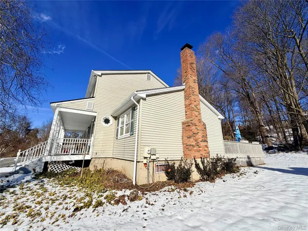 a view of a house with a snow in the yard