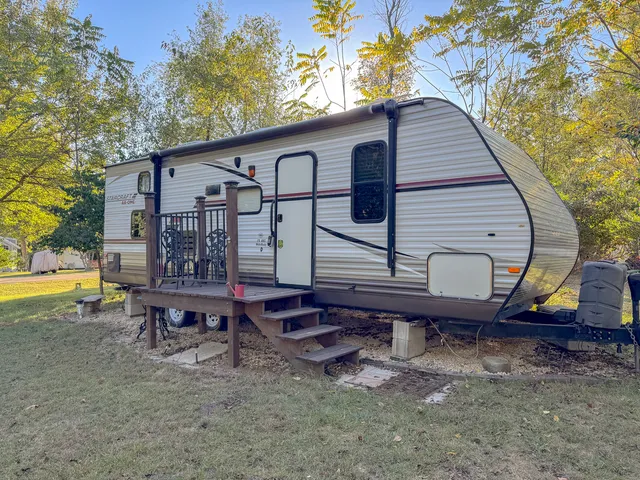 a view of a small house with a yard