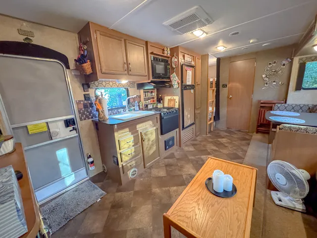 a kitchen with a refrigerator and a stove