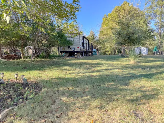 a swimming pool with outdoor seating and yard