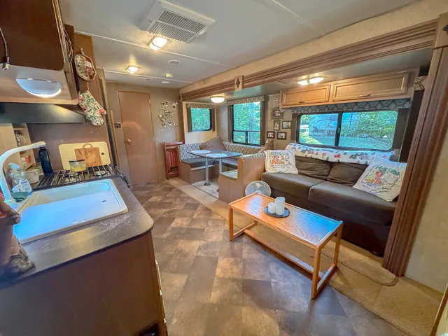 a kitchen with stainless steel appliances granite countertop a refrigerator a stove and a wooden cabinets