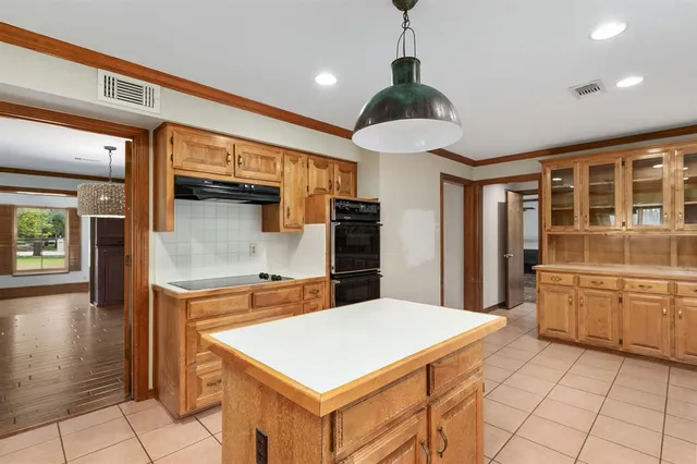 a view of a room with window wooden floor and chandelier