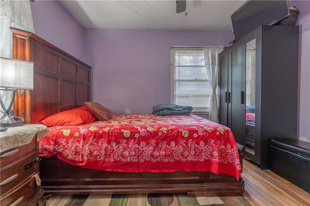 3554 Pine Street Atlanta, GA 30340 - Photo 17 of 21 a bedroom with a bed and wooden floor