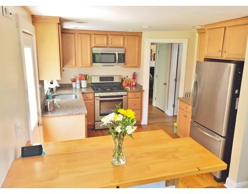 49 Weyham Road Weymouth, MA 02191 - Photo 6 of 36 a kitchen with stainless steel appliances a refrigerator a stove a sink a microwave and a refrigerator