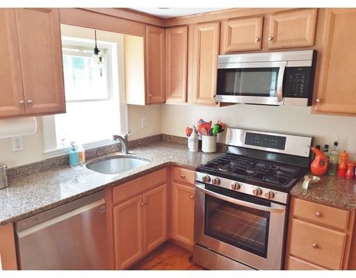49 Weyham Road Weymouth, MA 02191 - Photo 7 of 36 a kitchen with stainless steel appliances granite countertop a stove microwave and sink