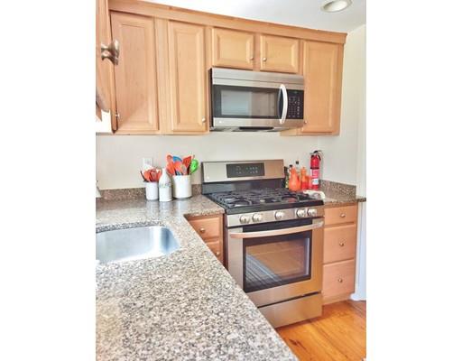 49 Weyham Road Weymouth, MA 02191 - Photo 8 of 36 a kitchen with stainless steel appliances granite countertop a stove top oven microwave and cabinets