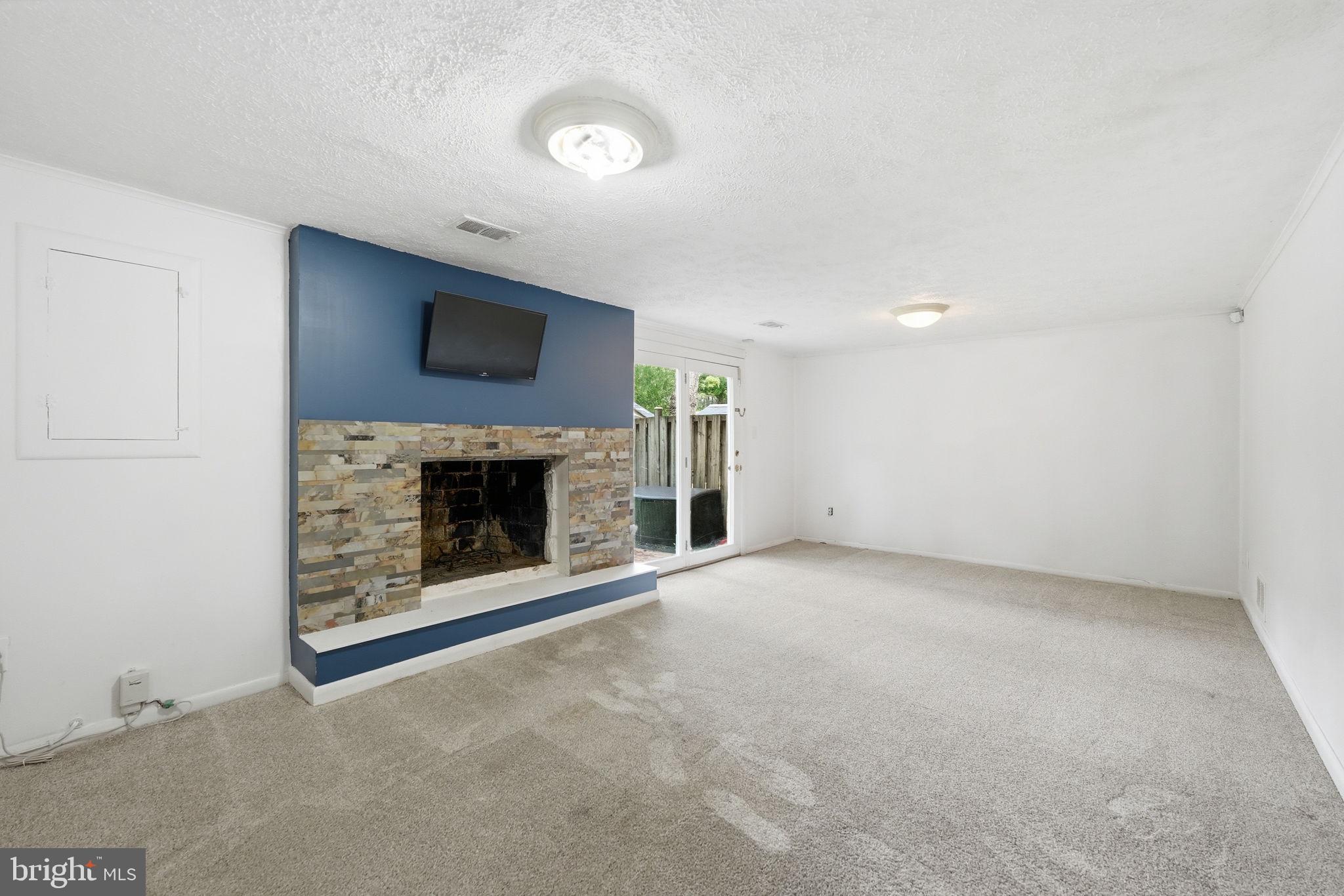8260 Getty Court Springfield, VA 22153 - Photo 24 of 31 an empty room with a fireplace and window