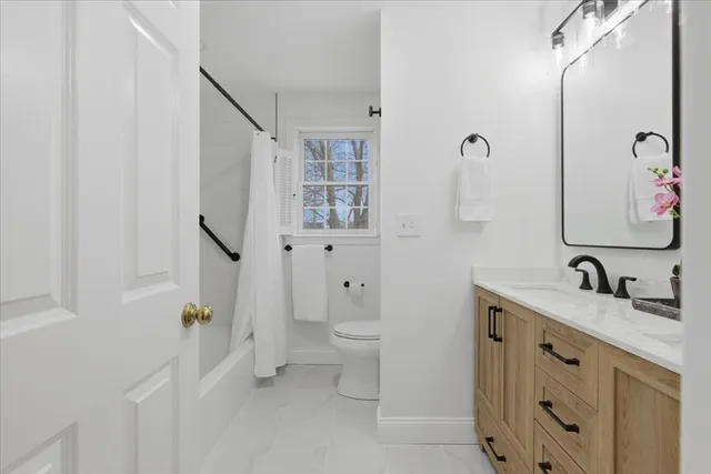 a bathroom with a double vanity sink toilet and shower