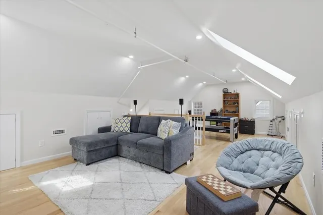 a living room with furniture kitchen and a table