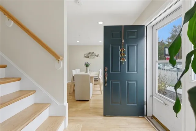 a view of entryway and hall with wooden floor