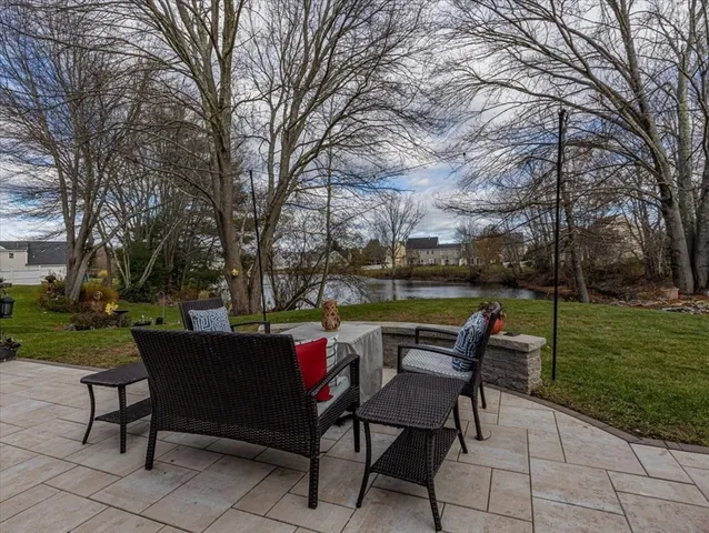 a backyard of a house with table and chairs
