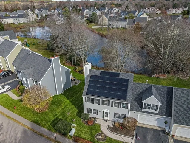 an aerial view of a house with garden space and lake view
