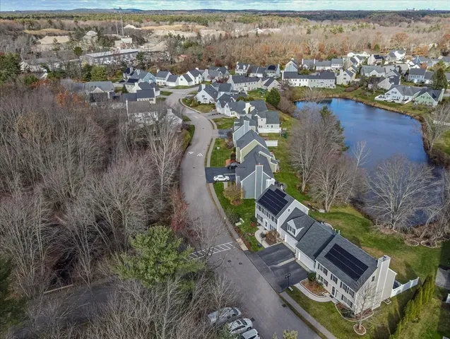 an aerial view of a house with outdoor space and lake view