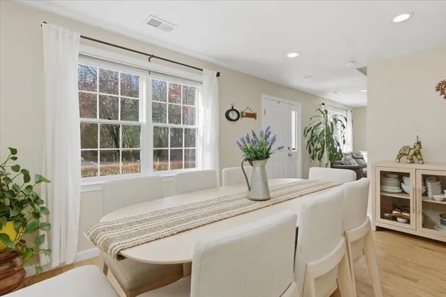 a dining room with kitchen island furniture and a potted plant