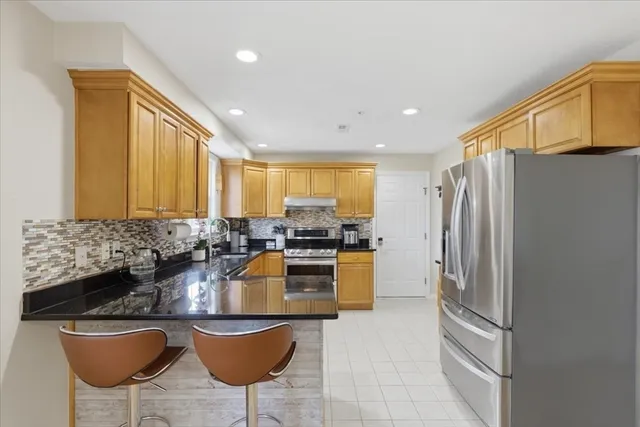 a kitchen with sink refrigerator and cabinets