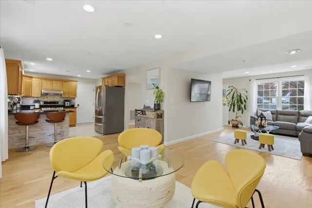 a living room with furniture and kitchen view