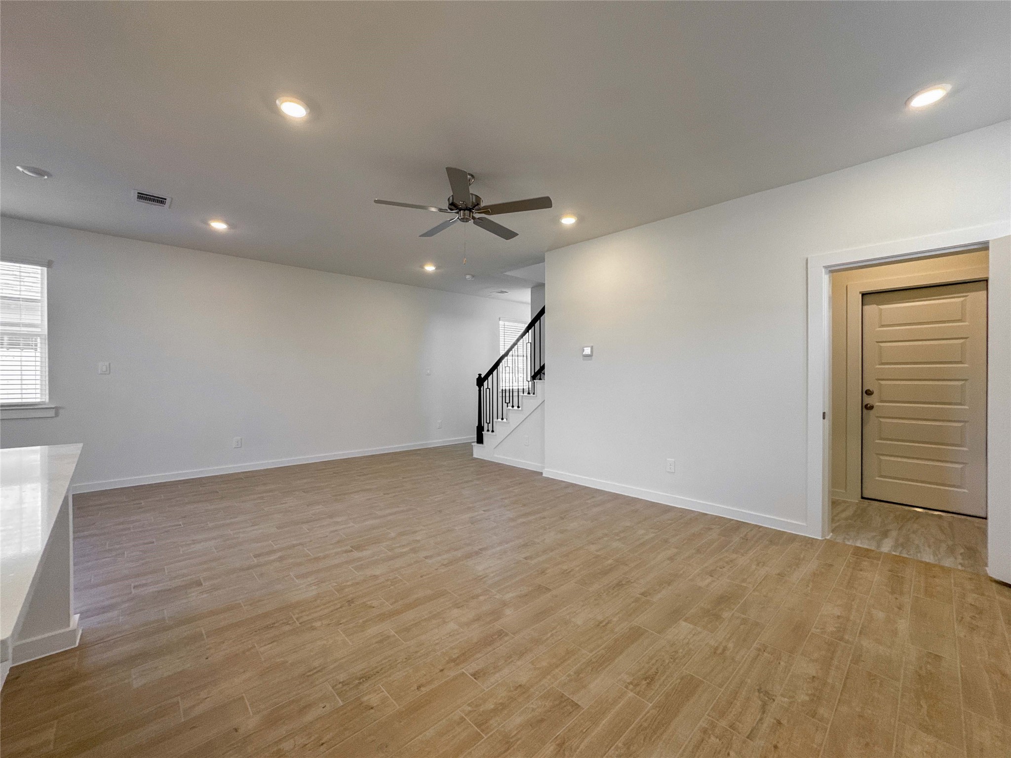 1115 Santee Court Rosharon, TX 77583 - Photo 12 of 24 an empty room with a ceiling fan and windows