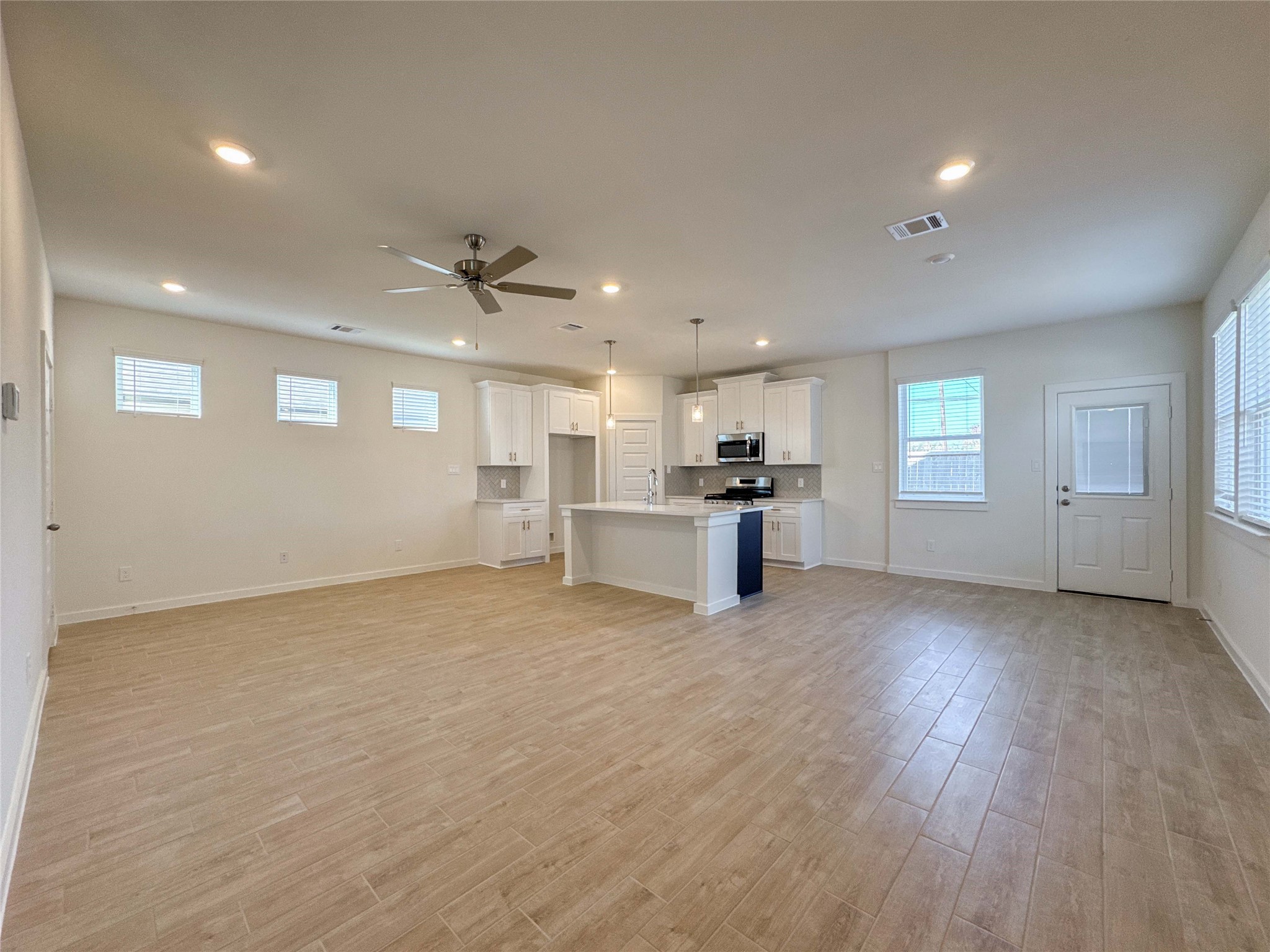 1115 Santee Court Rosharon, TX 77583 - Photo 4 of 24 a view of empty room with wooden floor and kitchen