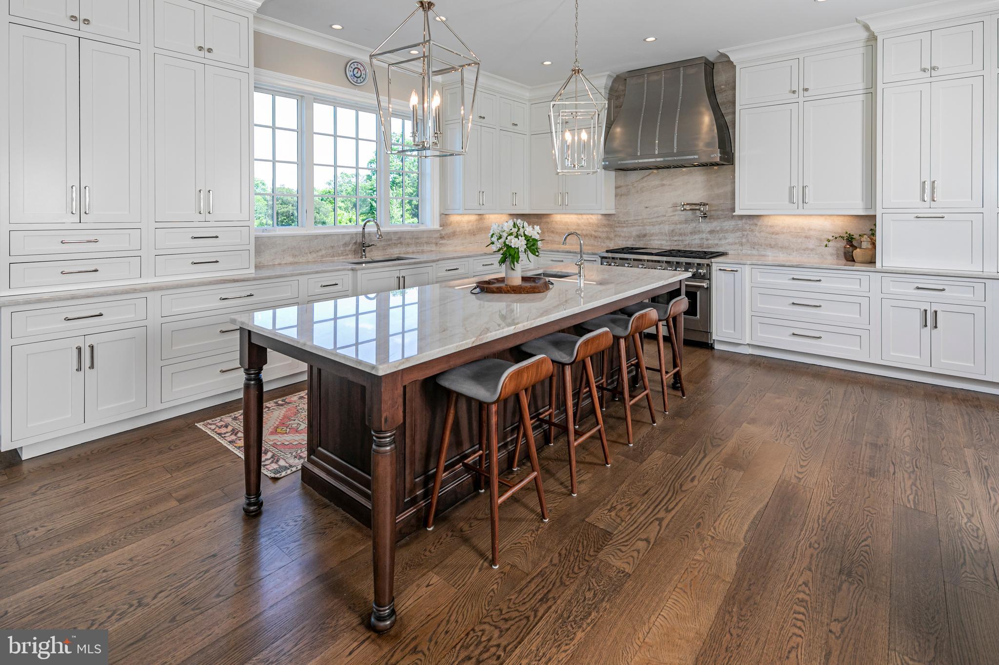 280 Carter Road Princeton, NJ 08540 - Photo 12 of 79 a kitchen with stainless steel appliances granite countertop a kitchen island hardwood floor sink stove and white cabinets