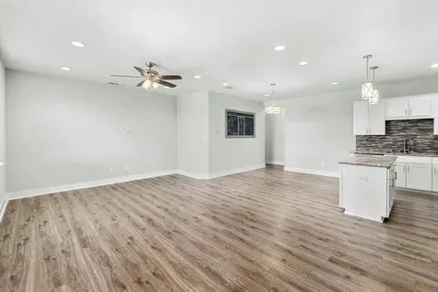 a view of kitchen with sink and wooden floor