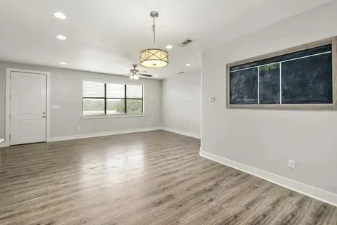 a kitchen with stainless steel appliances a refrigerator sink and white cabinets