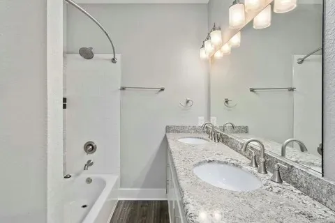 an empty room with a window and a ceiling fan