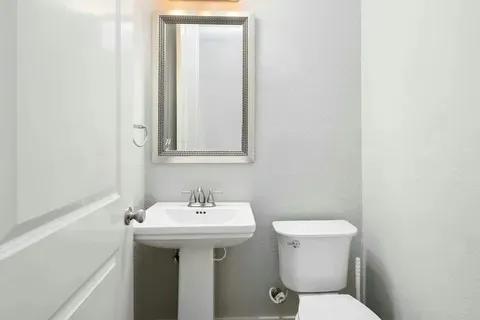 an empty room with a window and a ceiling fan