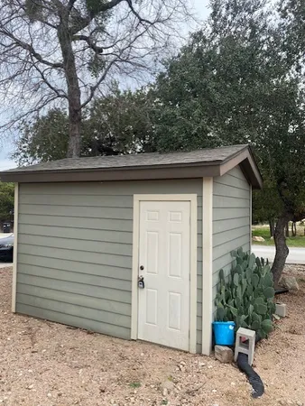 a side view of a house with a backyard