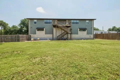 a view of a house with a yard and a garage