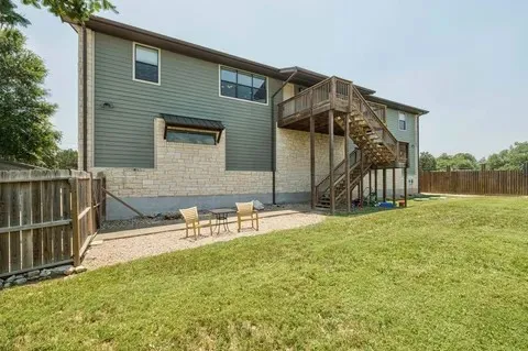 a view of backyard of house and car parked