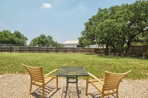 a view of a lake with a table and chairs