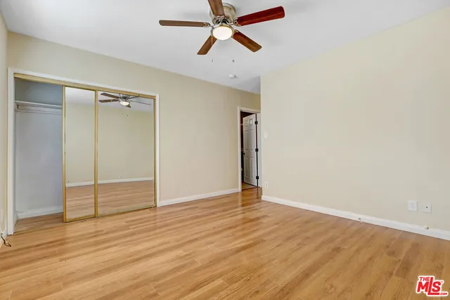 a view of an empty room and wooden floor