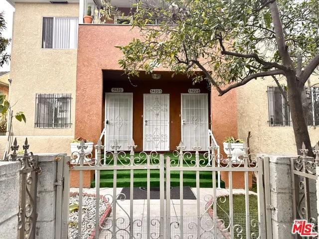 a view of a house with a large tree and windows