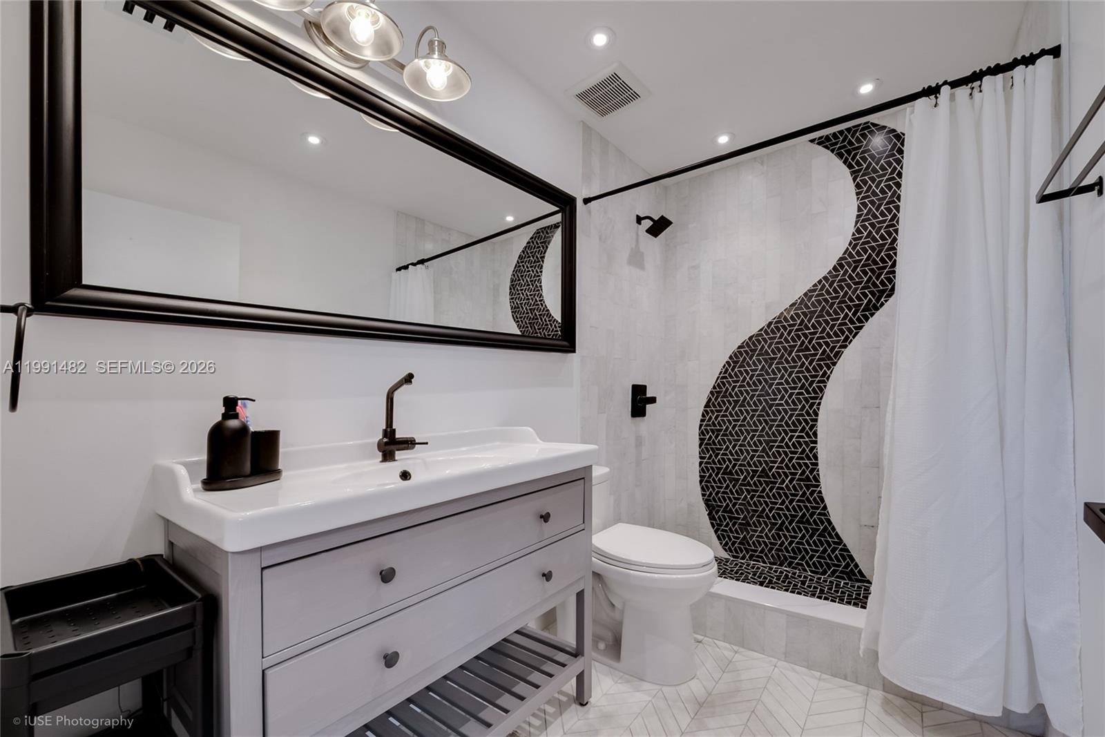 7940 Southwest 20th Street Miami, FL 33155 - Photo 13 of 29 a bathroom with a toilet a sink and mirror