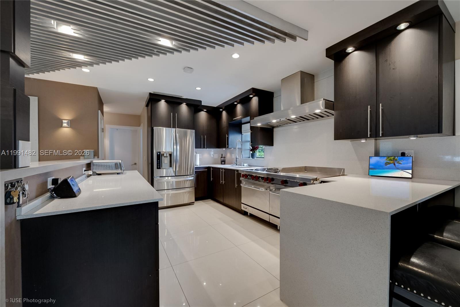 7940 Southwest 20th Street Miami, FL 33155 - Photo 3 of 29 a kitchen with stainless steel appliances kitchen island a sink stove and cabinets