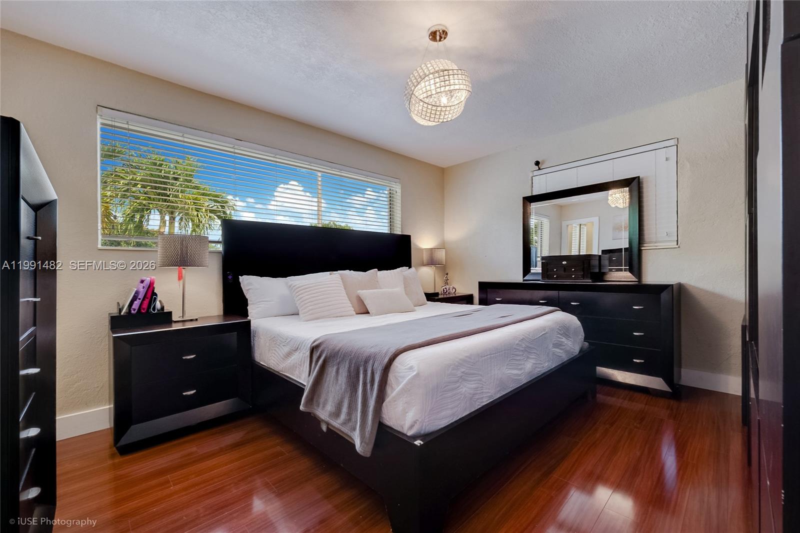 7940 Southwest 20th Street Miami, FL 33155 - Photo 5 of 29 a bedroom with a bed and a chandelier