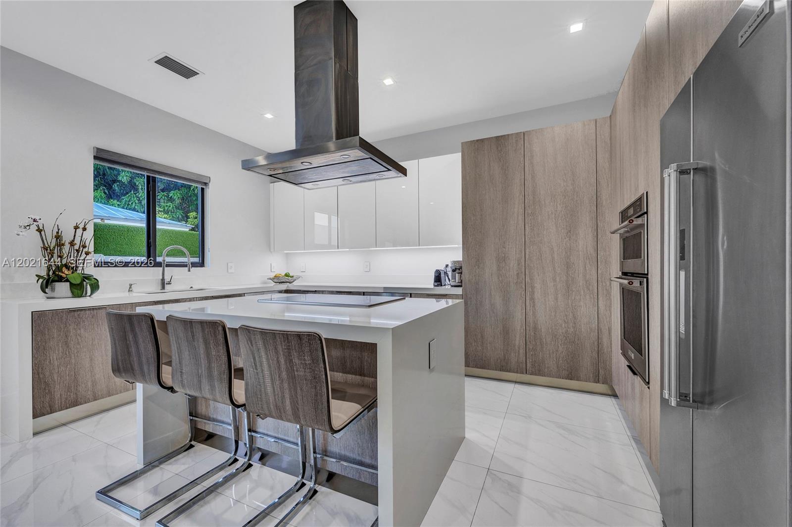 7800 Southwest 9th Terrace Miami, FL 33144 - Photo 34 of 64 a kitchen with stainless steel appliances a table chairs refrigerator and sink