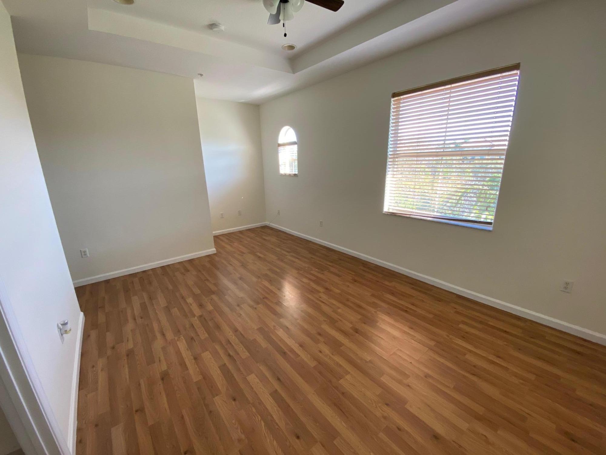 1272 Via Fiume Boynton Beach, FL 33426 - Photo 12 of 51 a view of an empty room with wooden floor and a window