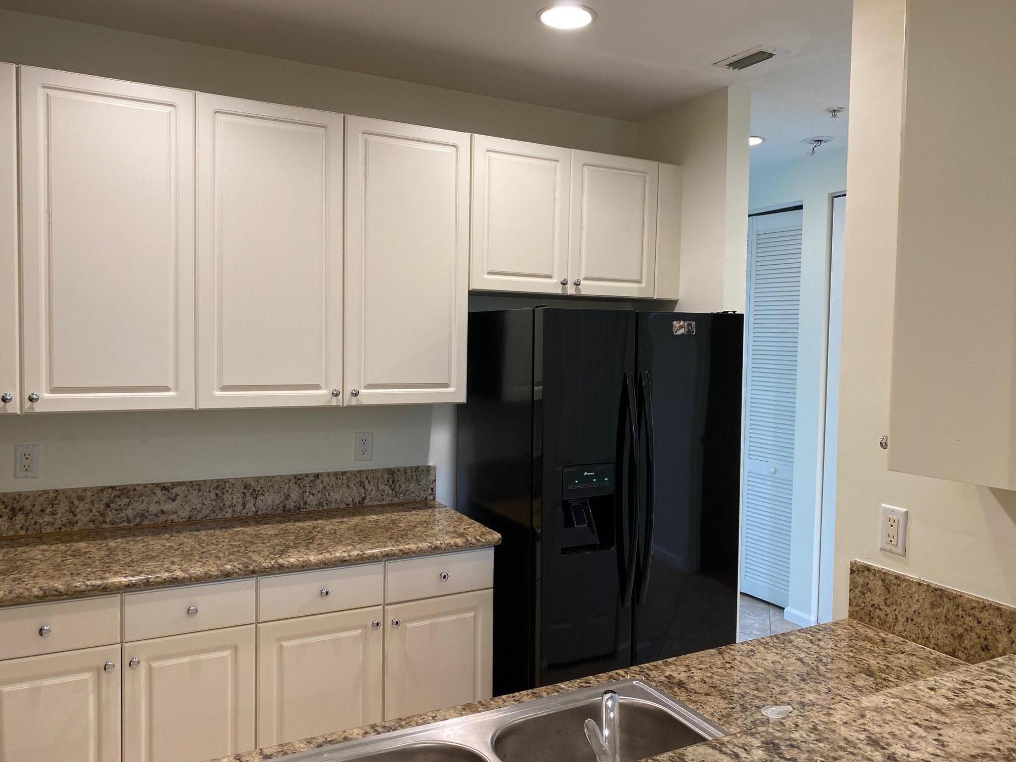 1272 Via Fiume Boynton Beach, FL 33426 - Photo 4 of 51 a kitchen with granite countertop white cabinets and refrigerator