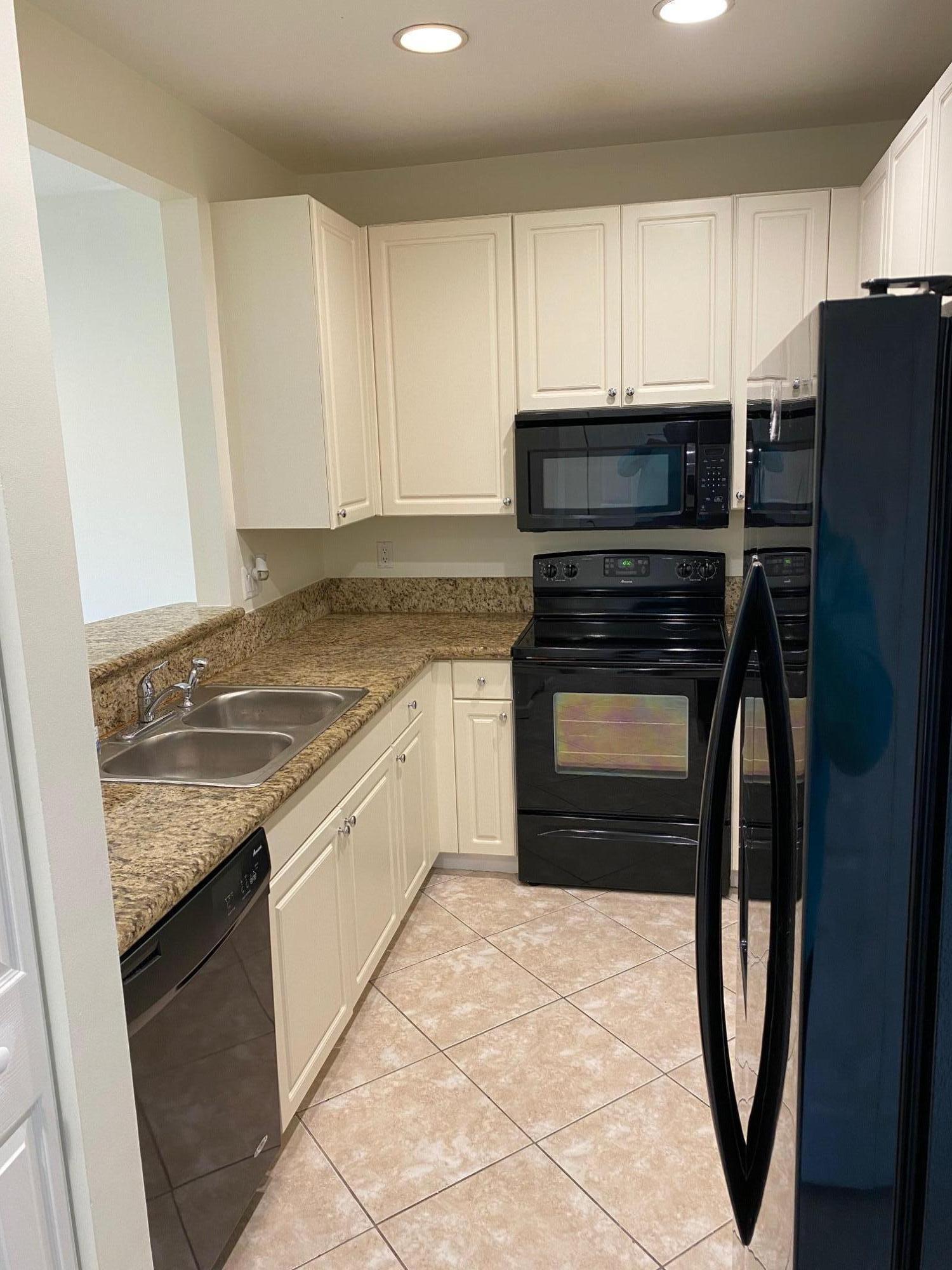 1272 Via Fiume Boynton Beach, FL 33426 - Photo 6 of 51 a kitchen with granite countertop a refrigerator stove and oven