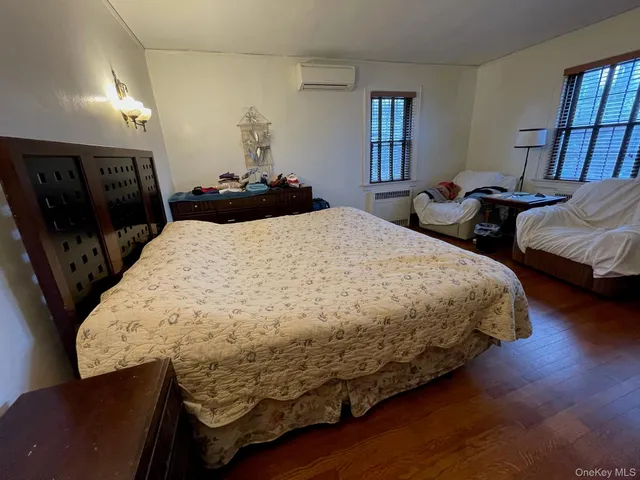 a bed sitting in a bedroom and night stand