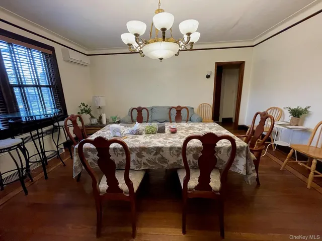 a view of a dining room with furniture and chandelier