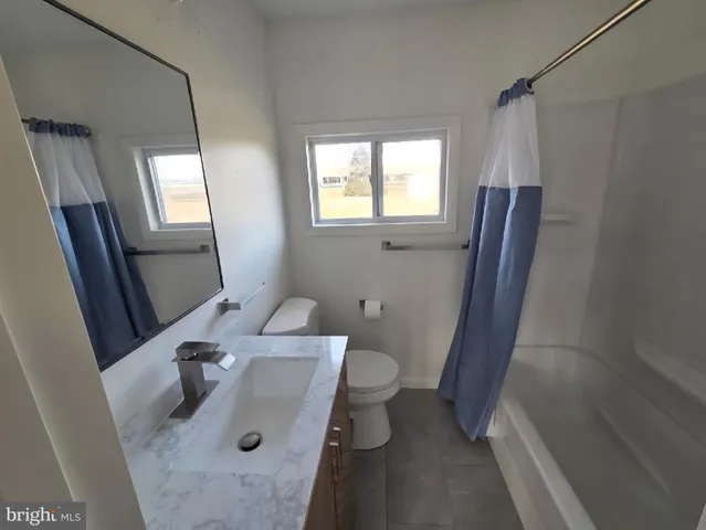 a bathroom with a sink a mirror and shower
